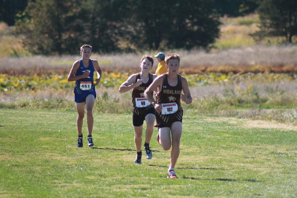 Nathan Caudill (43rd) and Gage Rudd (44th) passing a runner and racing each other to the finish line