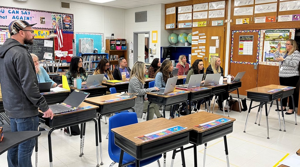 Westfield teachers sit at desks during professional development session