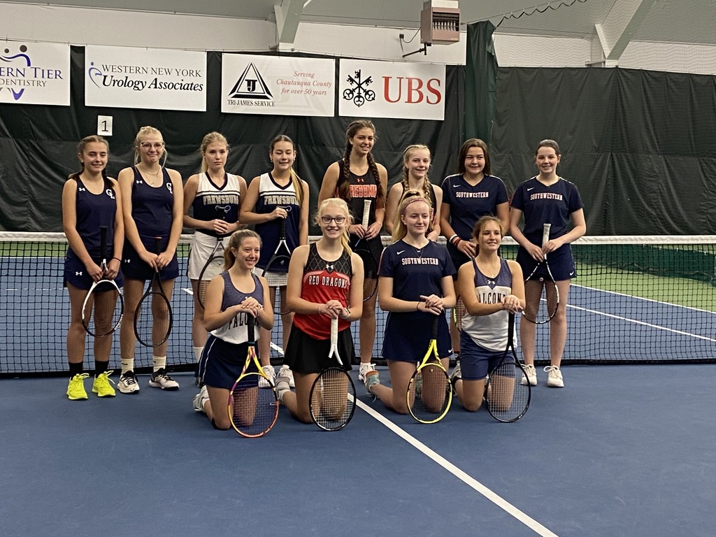 a group of girls tennis players pose with their rackets