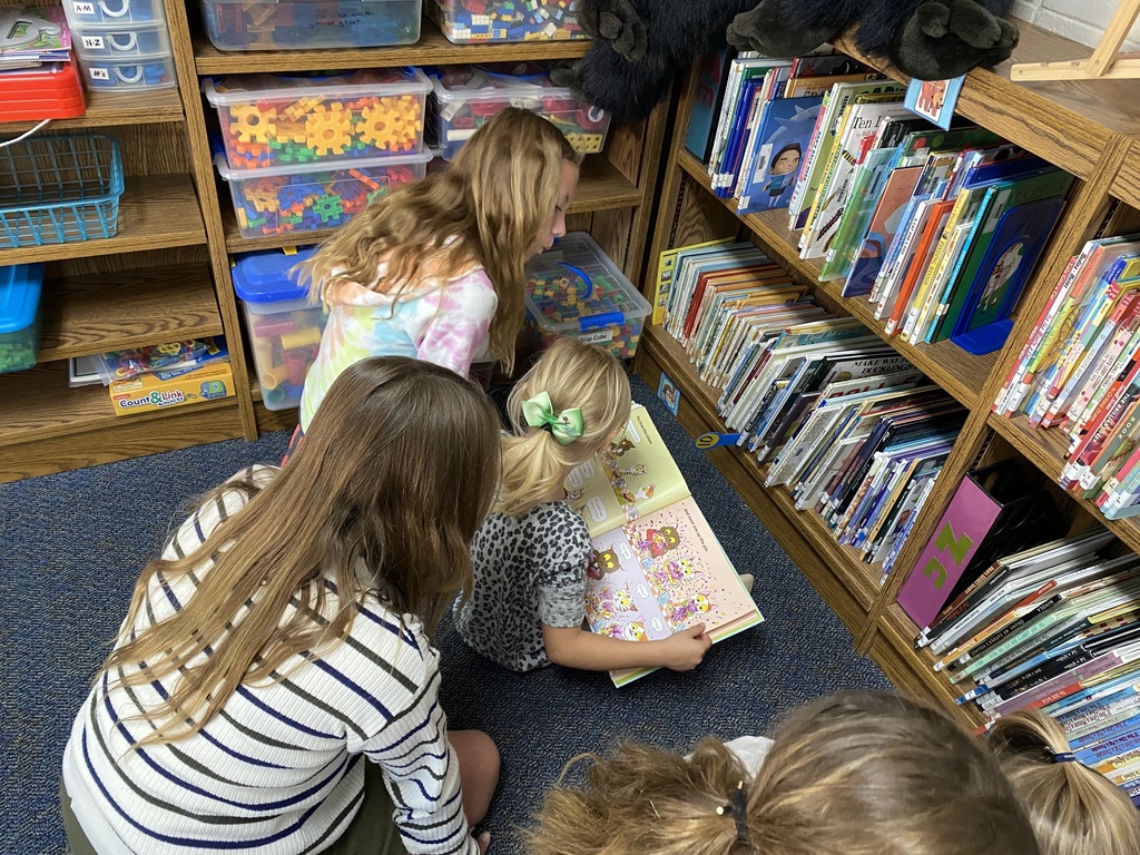 6th graders and kinders in the library