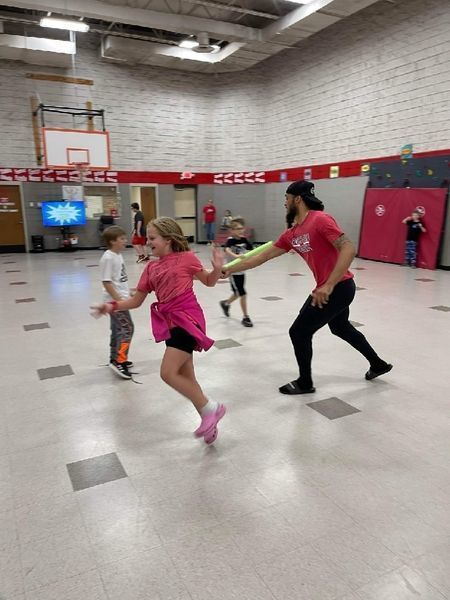 RSU athlete in gym with students 