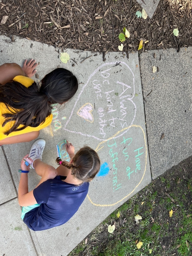 Two 4th grade female students draw their positive messages.