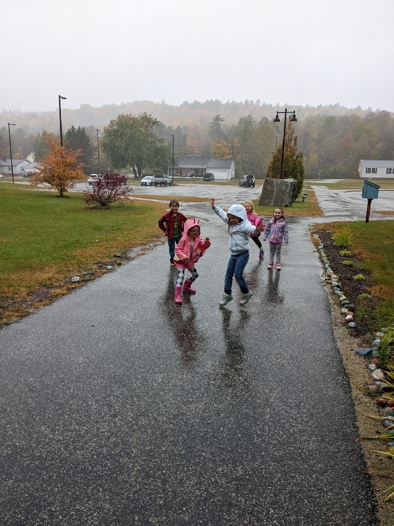 Pre-K students dancing in the rain