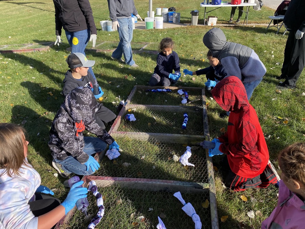 Students tie dying shirts outside