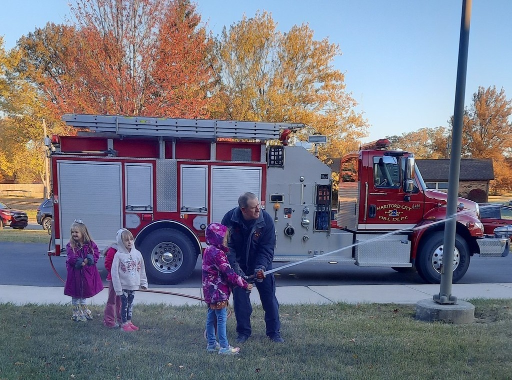 Student tries out the fire hose