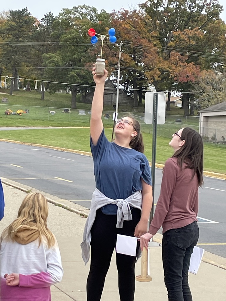 students with a weather tool