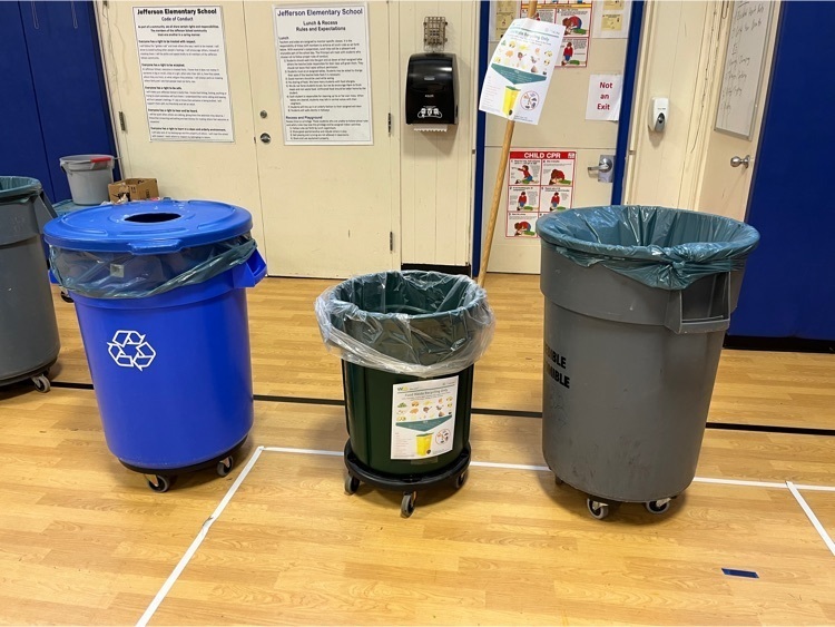 Three barrels- blue for recycling, green for food waste and gray for trash.