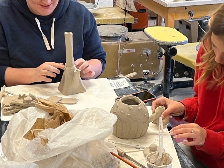 students working on their clay projectors 