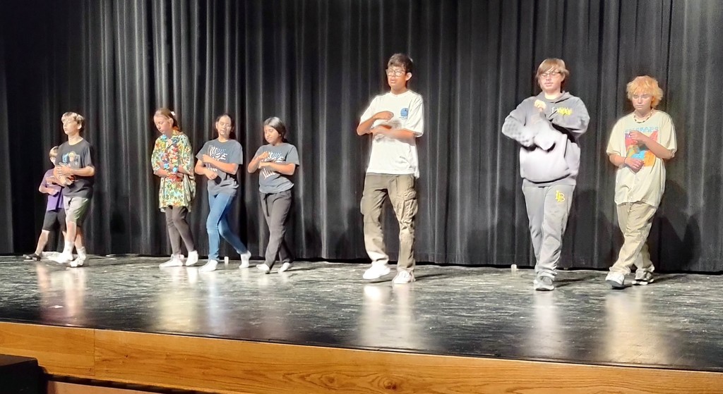 Students dancing on stage.