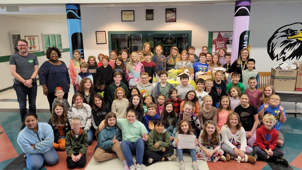 EHE SCA members with Mr. Foster, Mrs. White, Dr. Gelbert, and Mrs. Lane in the EHE lobby posing in front of the items collected