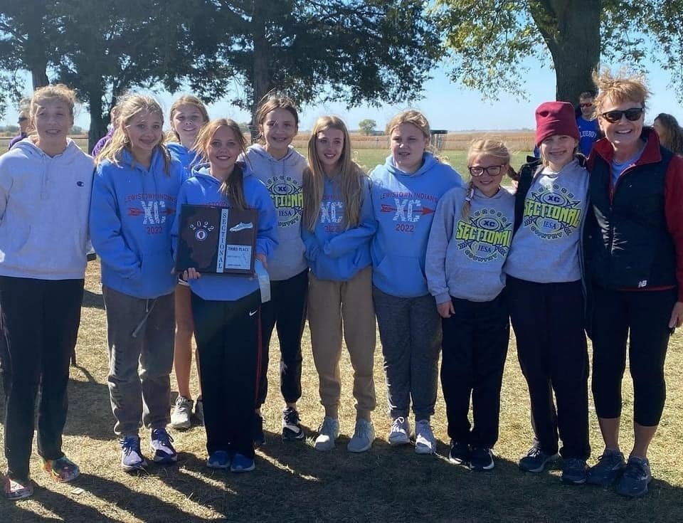 Cross country runners smiling outdoors