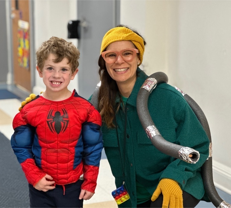 Student and principal posing in Halloween costumes