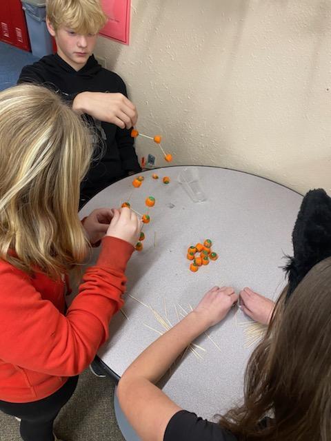 Kids are building with pumpkins.
