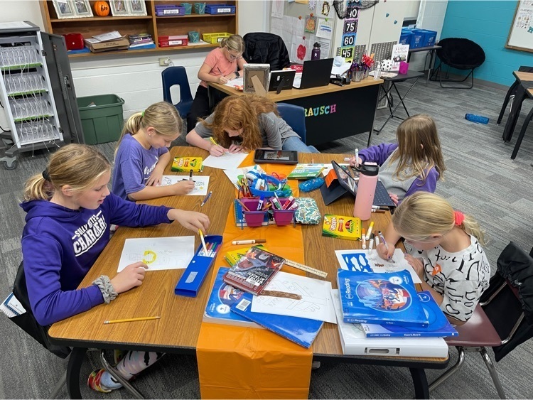 Students finishing up their writings and illustrations.