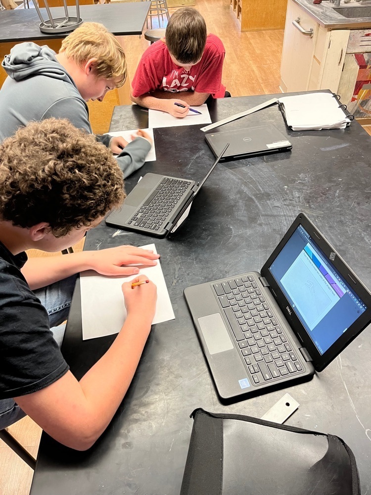 Students working on their drawings.