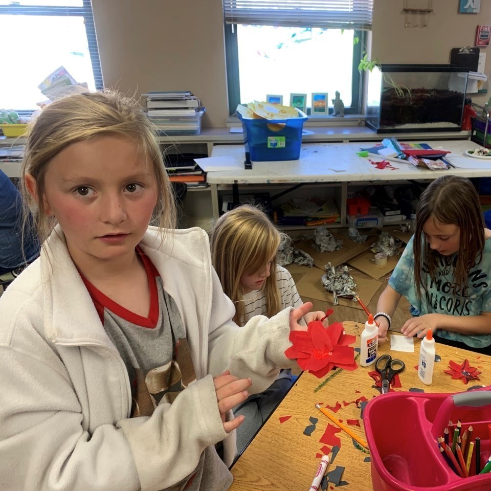 An AvP student holds up a poppy she has made for veterans