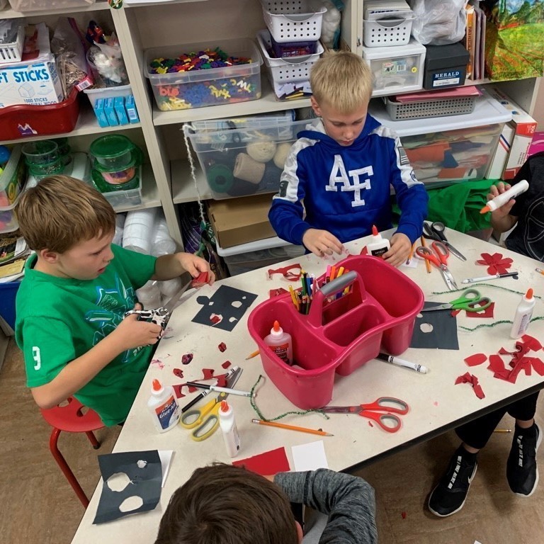 Third graders work together to make poppies