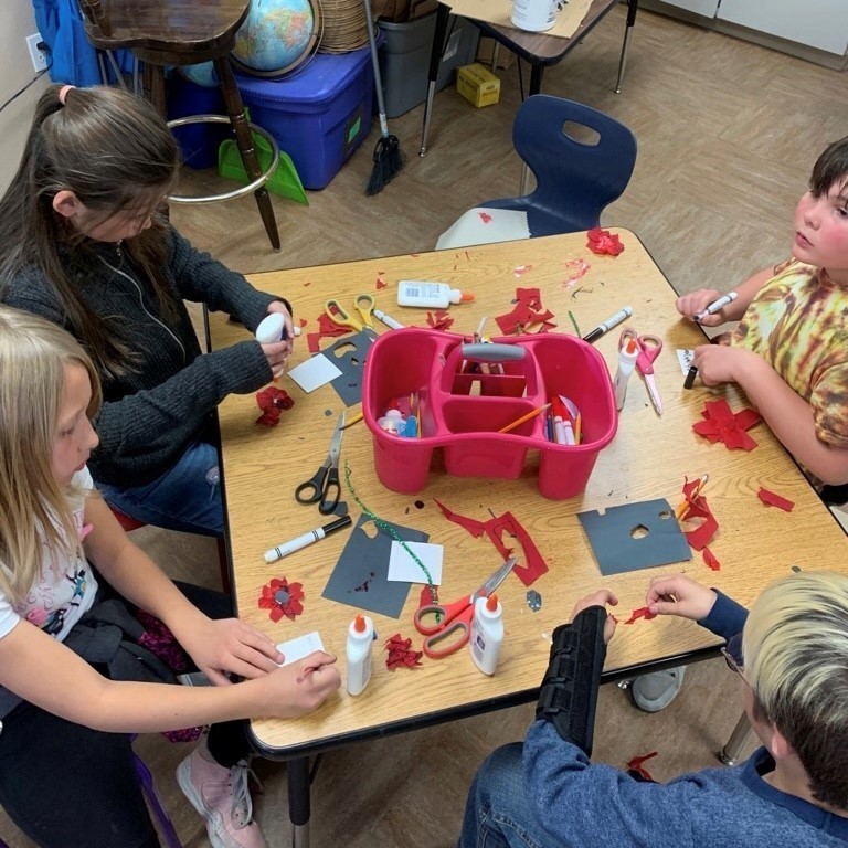 Students gave their finished poppies to veterans