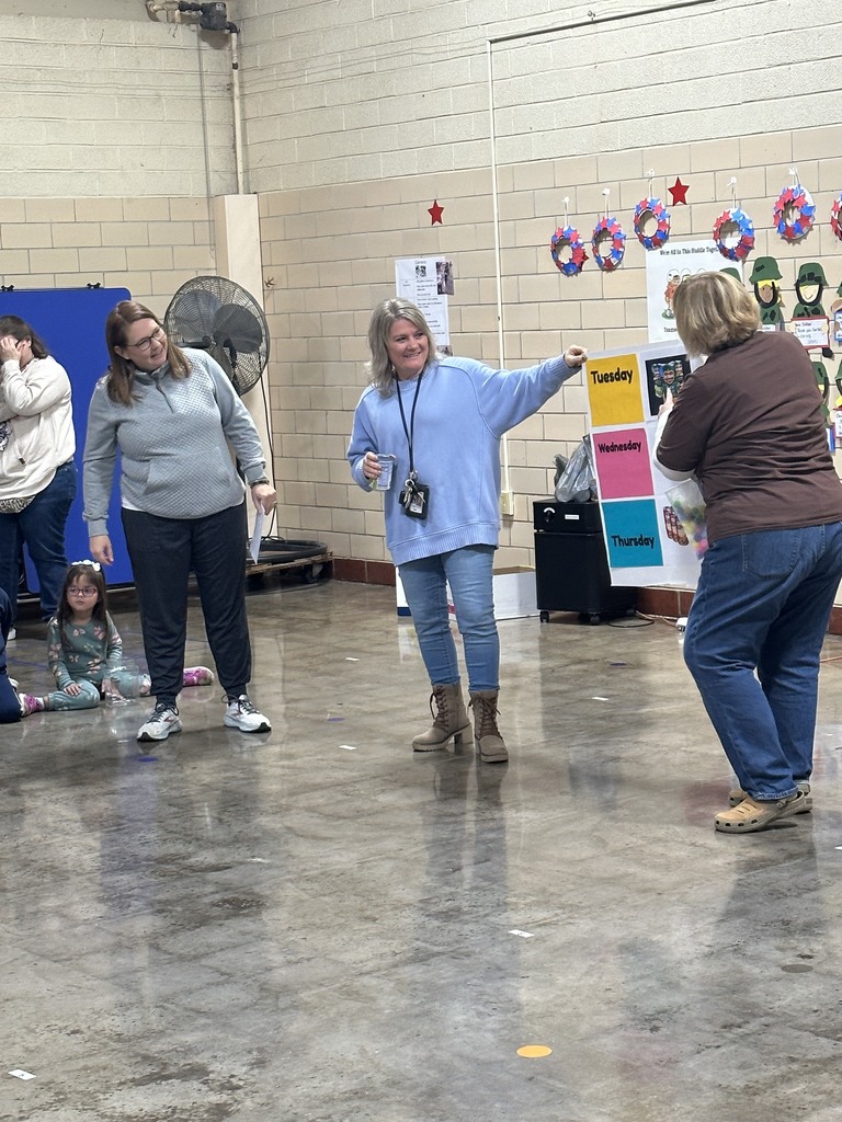 Teachers presenting the ELC Food Drive Days Poster