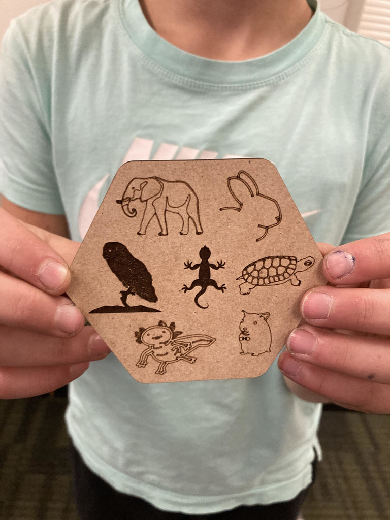 Pictured here is Lab Cats club member Callie Reed with the coaster she designed and created on the Florence Elementary Glowforge laser engraver. Awesome job Callie!!! #GoFloCats 💚💛