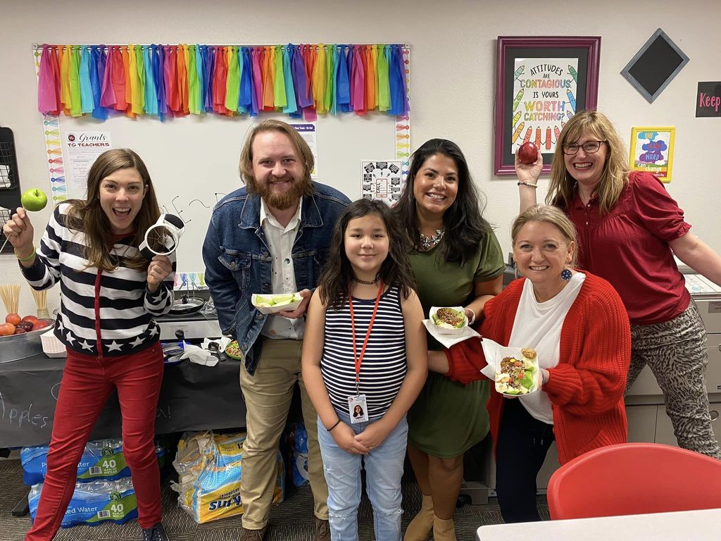 Teachers and Student holding food made by student