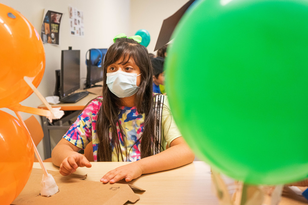 Child admiring her balloon design