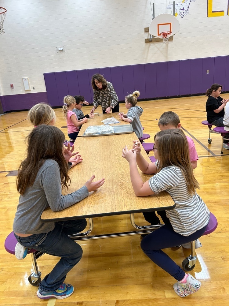 Second graders making bread.