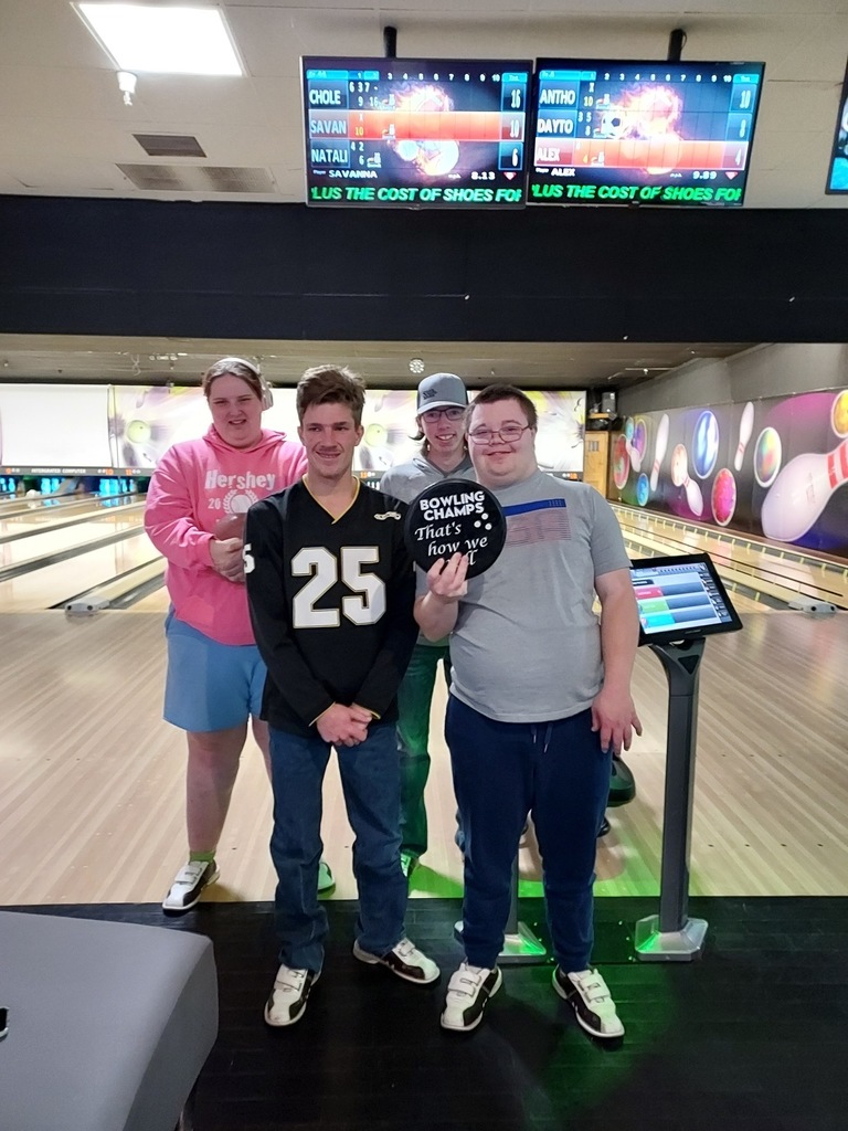 Owls student with the bowling trophy.