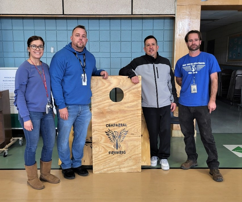 Team from ECO with cornhole boards