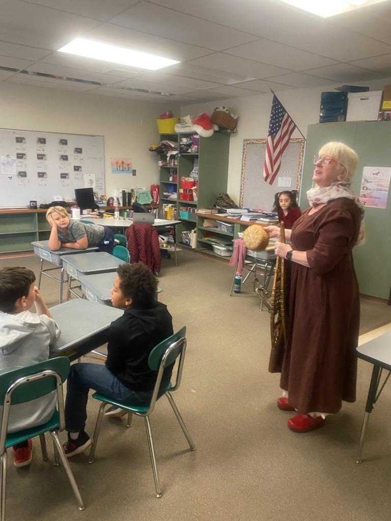 Ms. Johnson showing an artifact