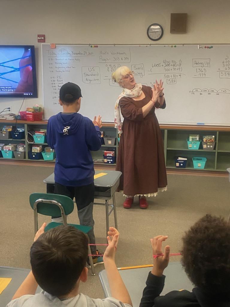 Ms. Johnson teaching a string game