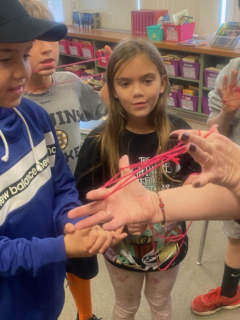 Students playing the string game