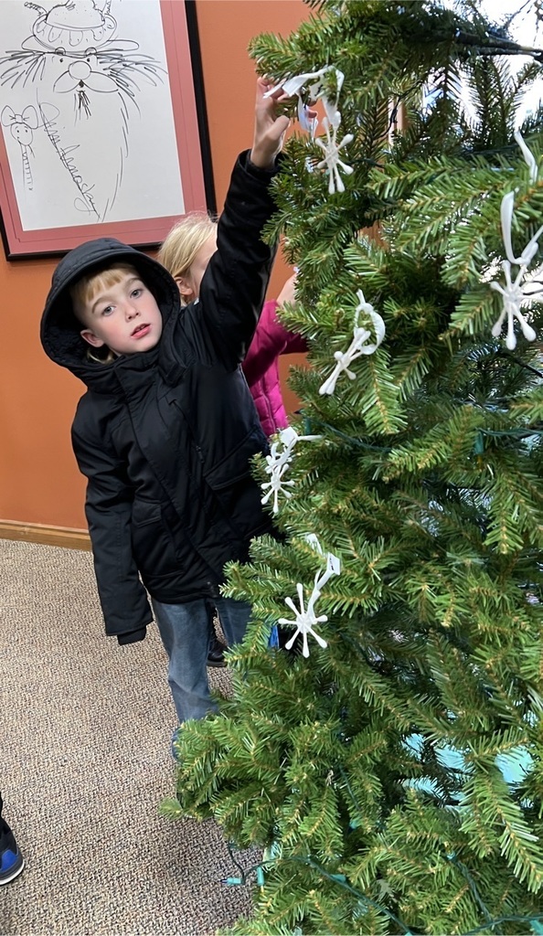 student putting up ornament