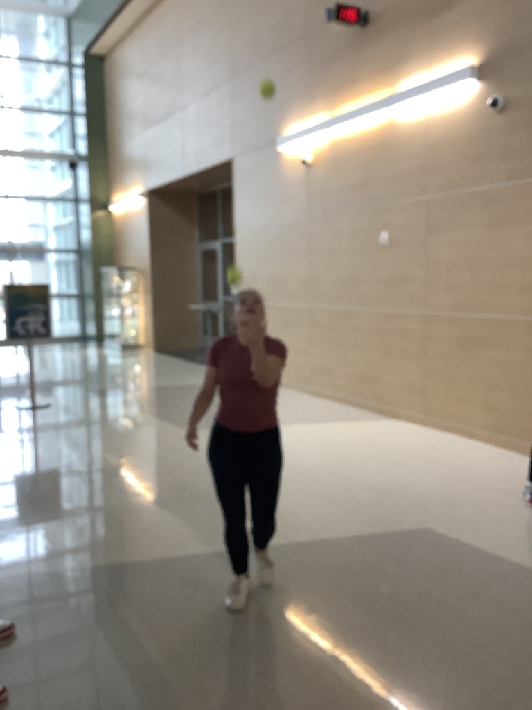 Student juggling two tennis balls