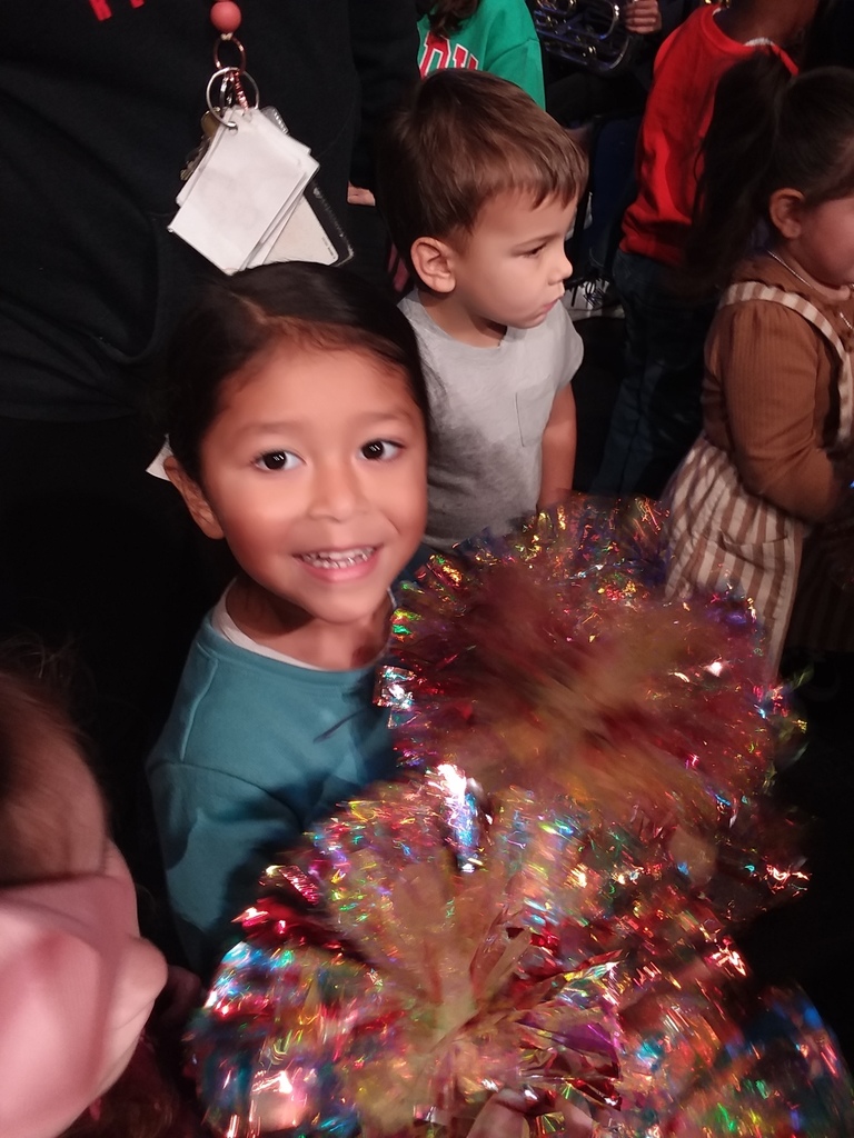 Child hold pom poms