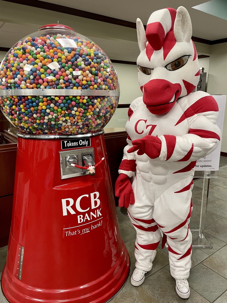 Zebra mascot and elf by gumball machine