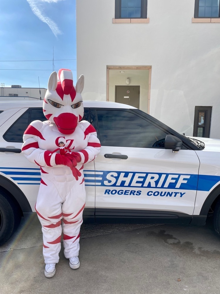 zebra mascot and elf by police car