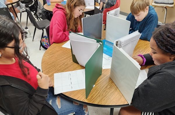students playing battleship math game