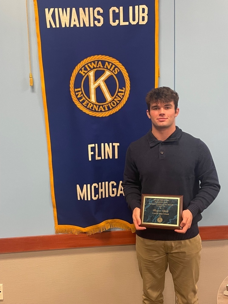 male student holding plaque 