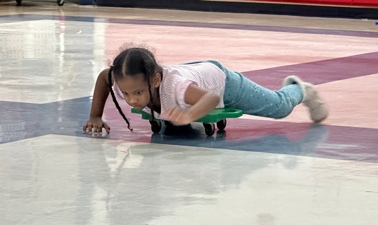 student participating in scooter relays