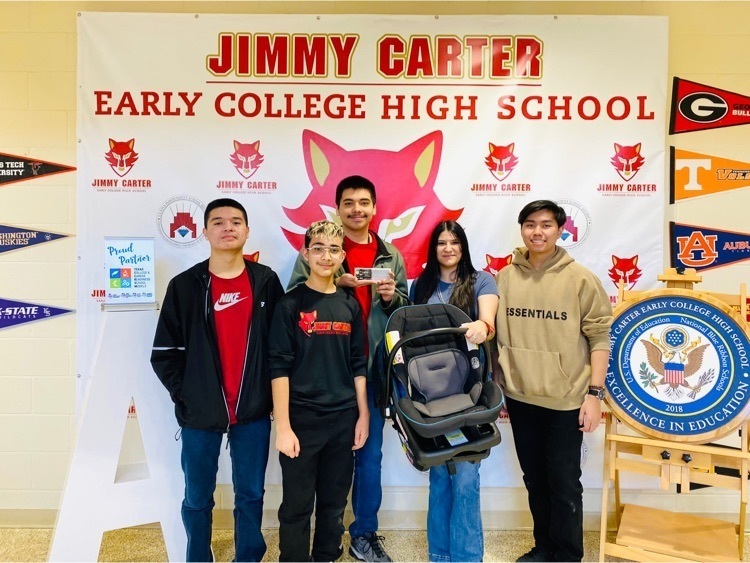 Our Cyber Techies posing for a photo with their car seat heat sensor prototype .