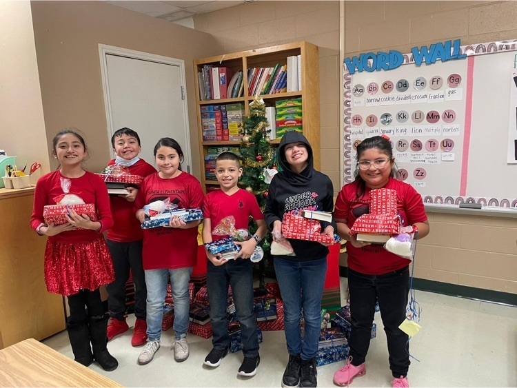 Students receiving presents from our JCECHS toy drive.