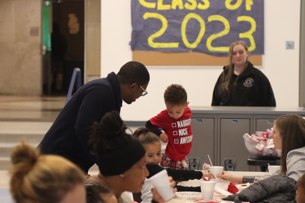 Mr. Russell talking to a child at Santa Breakfast