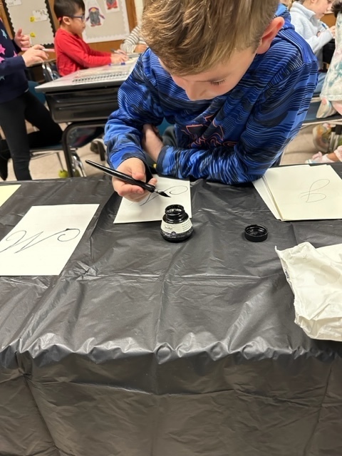 second grade boy doing calligraphy writing