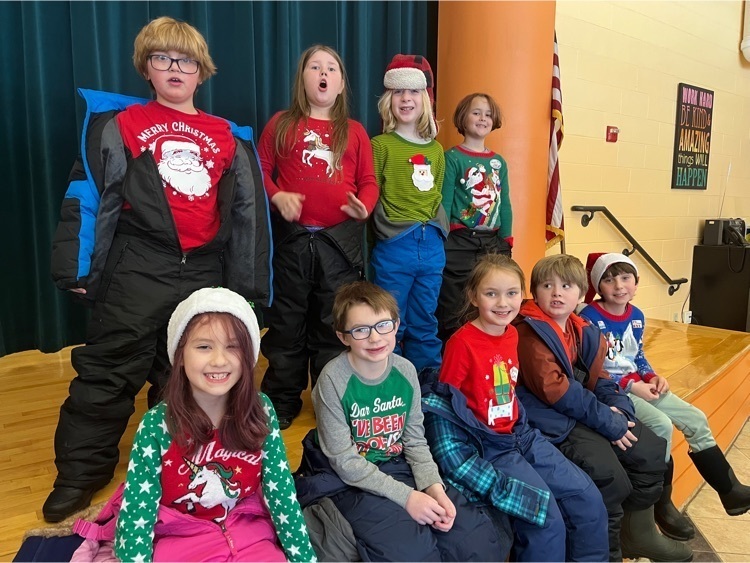 second graders dressed in holiday festive outfits 