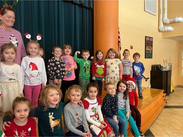 kindergartners dressed in holiday festive outfits 