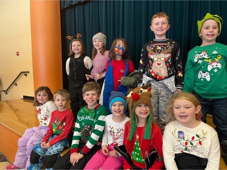 second graders dressed in holiday festive outfits 