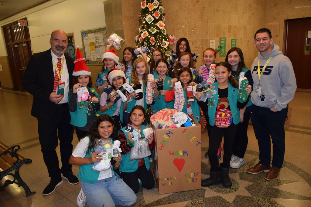 Building Principal and AP pose with students showcasing fundraising efforts