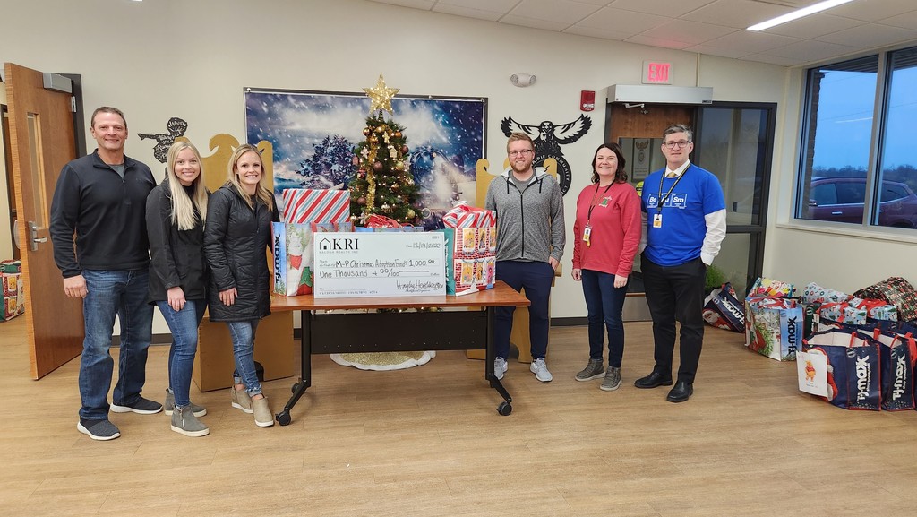 Kalona Realty presenting $1000 check to MP