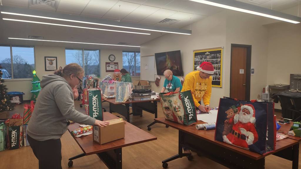 Community members wrapping presents